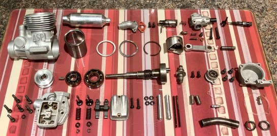 Engine parts layed out following a good clean to remove all that nasty castor oil. The bearings were smooth enough so despite the handling it's suffered I don't think it's actually had many hours run time.