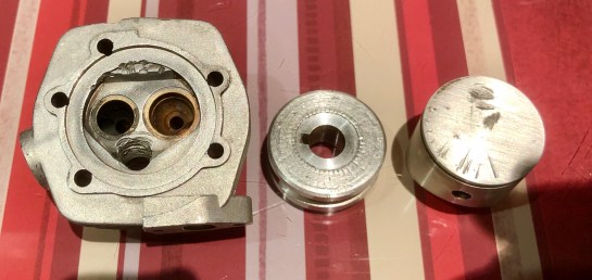 Curious damage to glow threads, combustion chamber, prop driver and piston. Yet those valves seats were fine and the marks on the pistion didn't line up with the poppets. Was the damage terminal though?